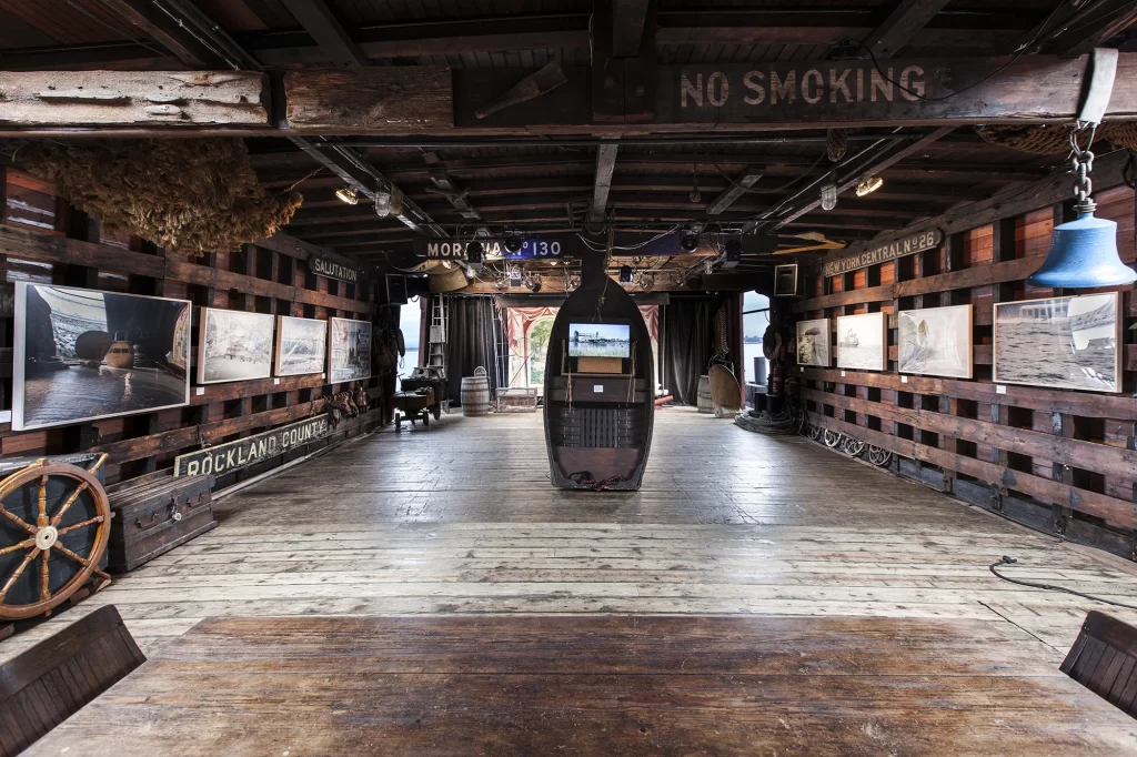 Barge interior with an art show hung