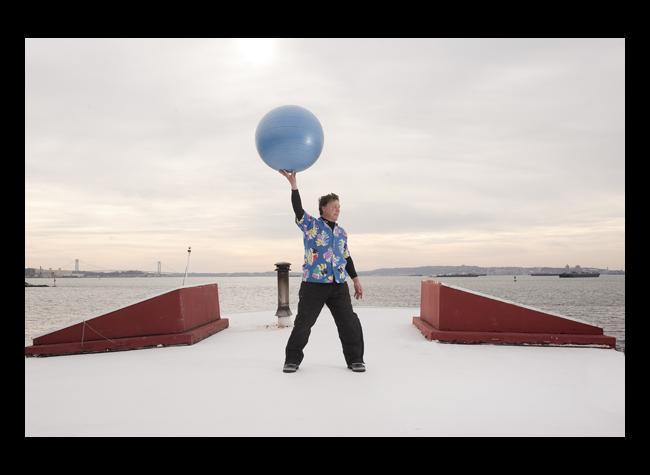 David on the top of the barge holding a large ball